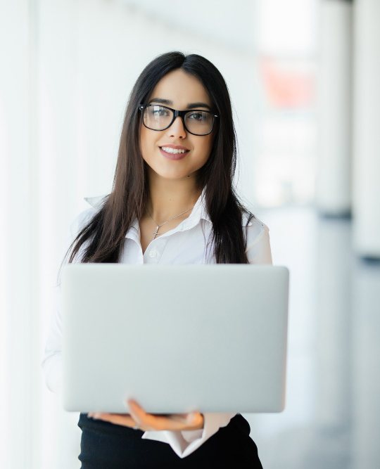 Consultant holding a laptop in a city office